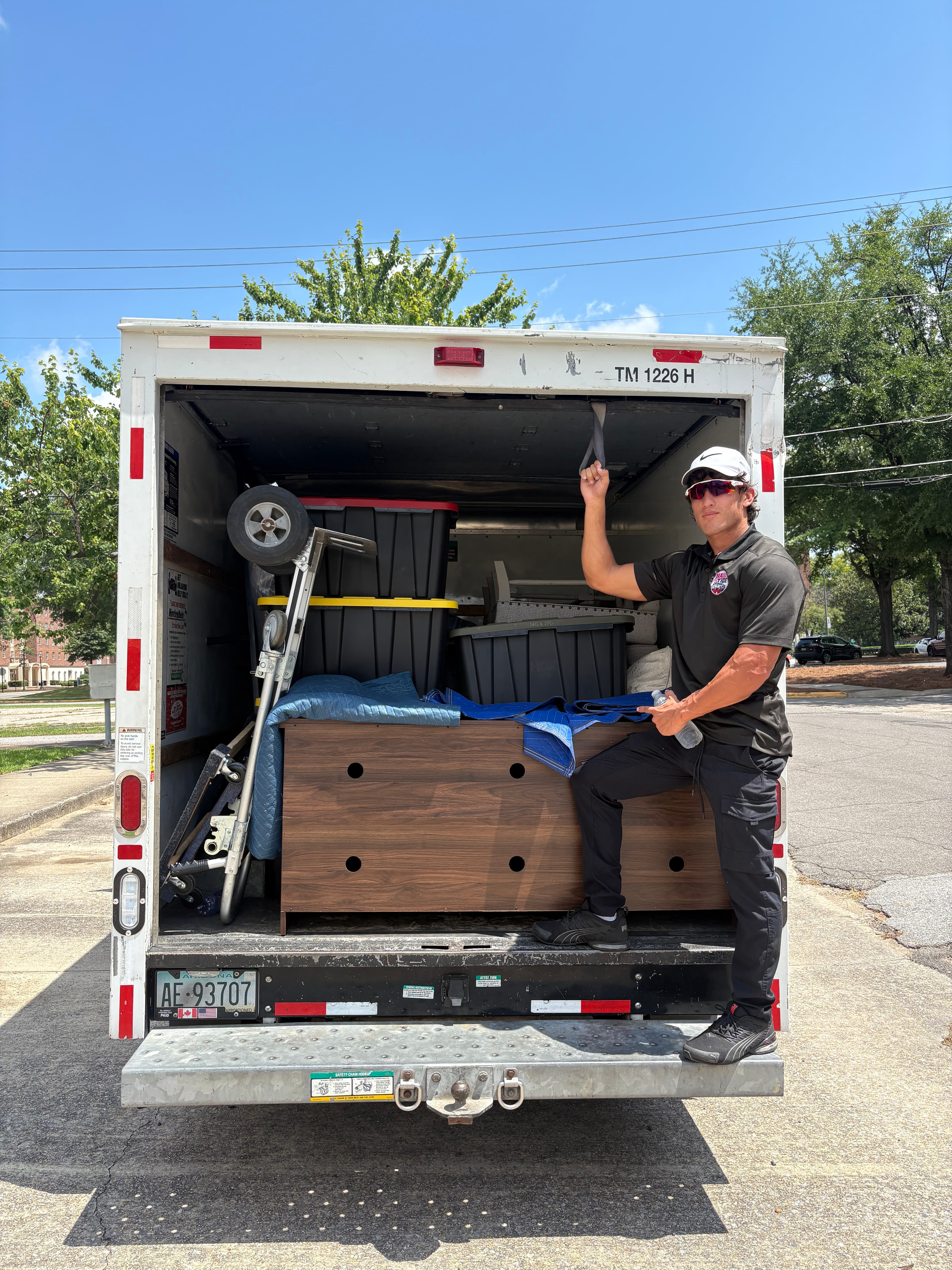 Haul Tide movers carrying furniture on a Tuscaloosa job