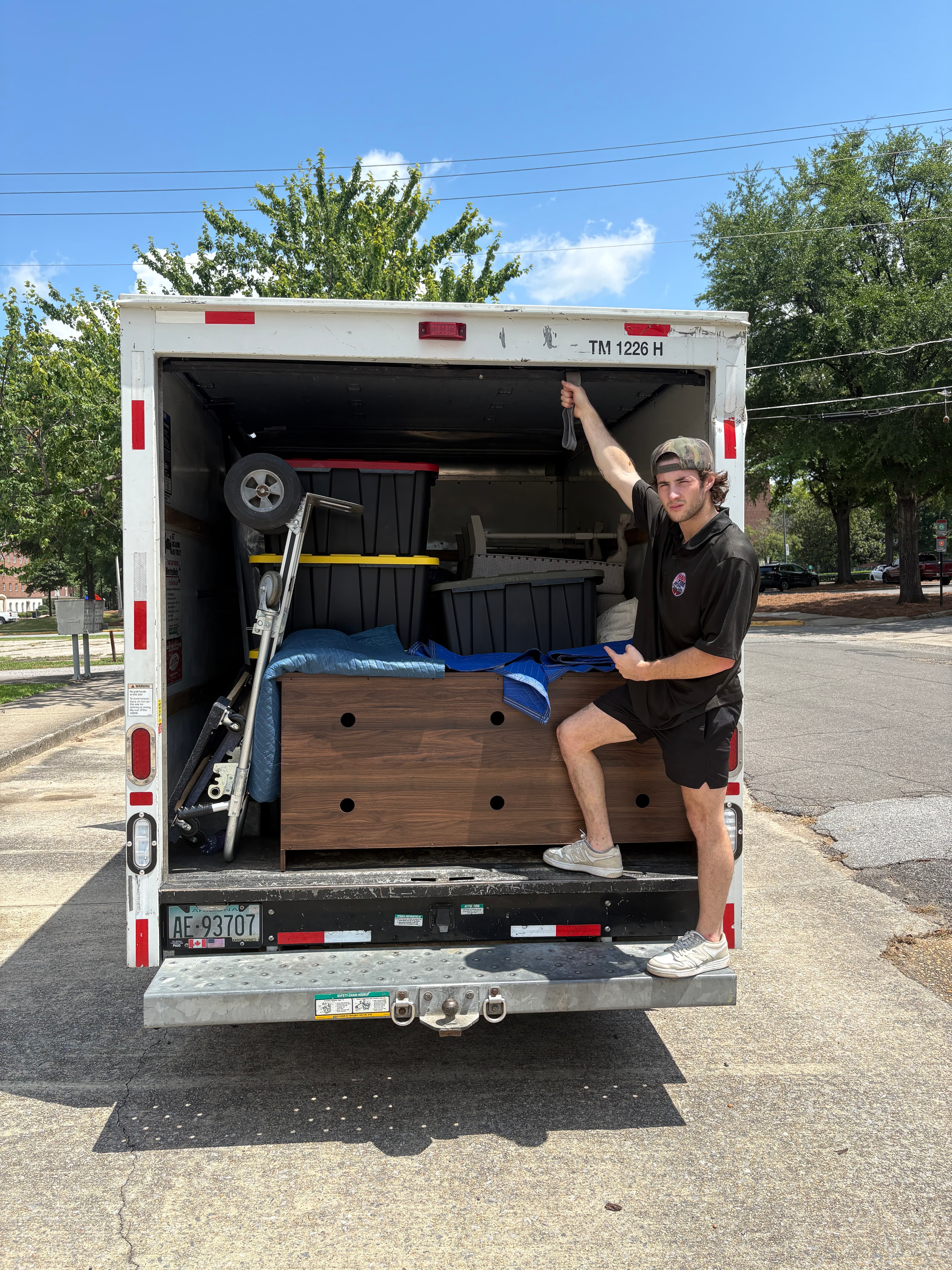 Two Haul Tide movers loading household items during a Tuscaloosa move