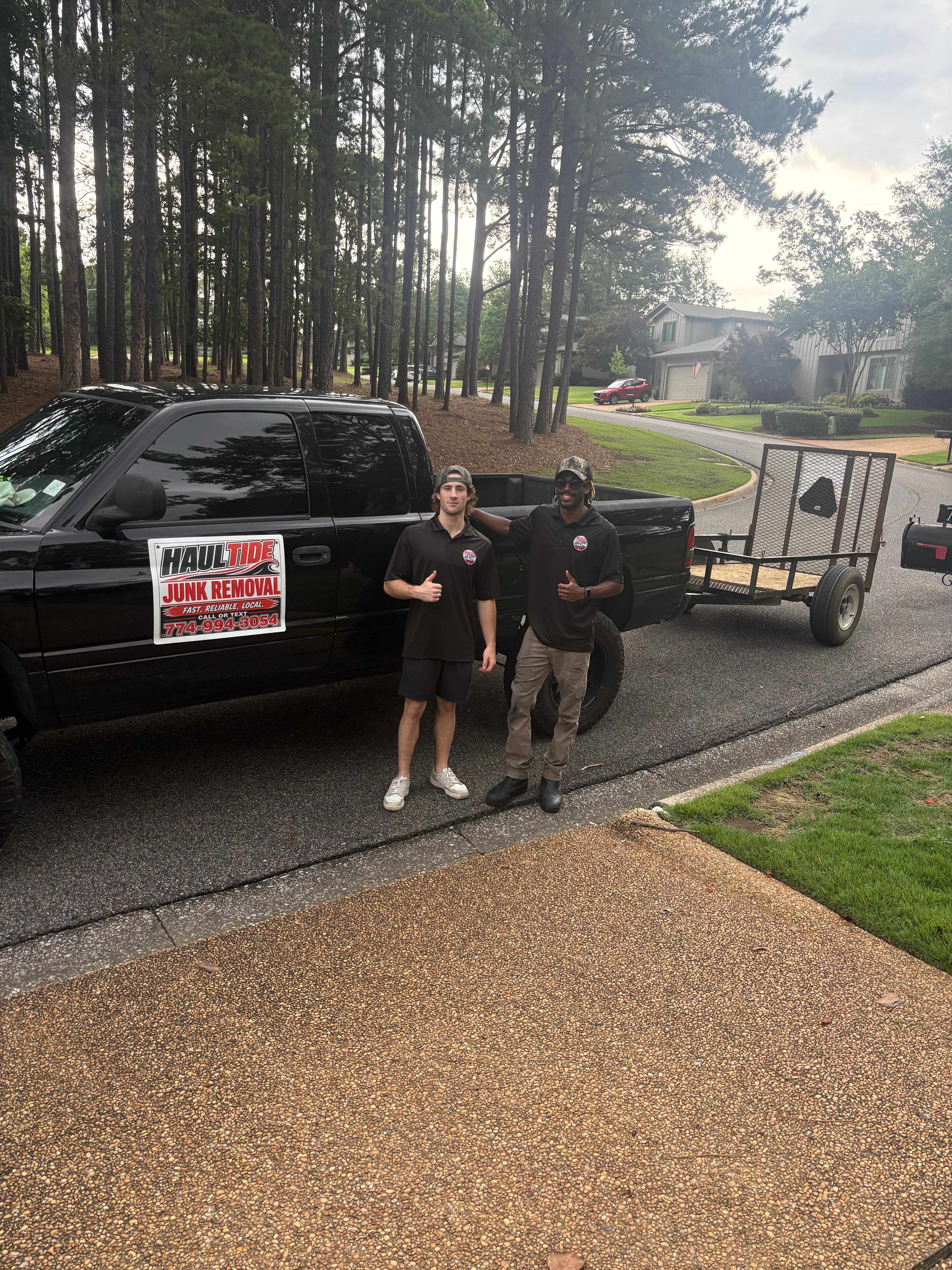 Haul Tide crew standing with the truck and moving trailer in Tuscaloosa