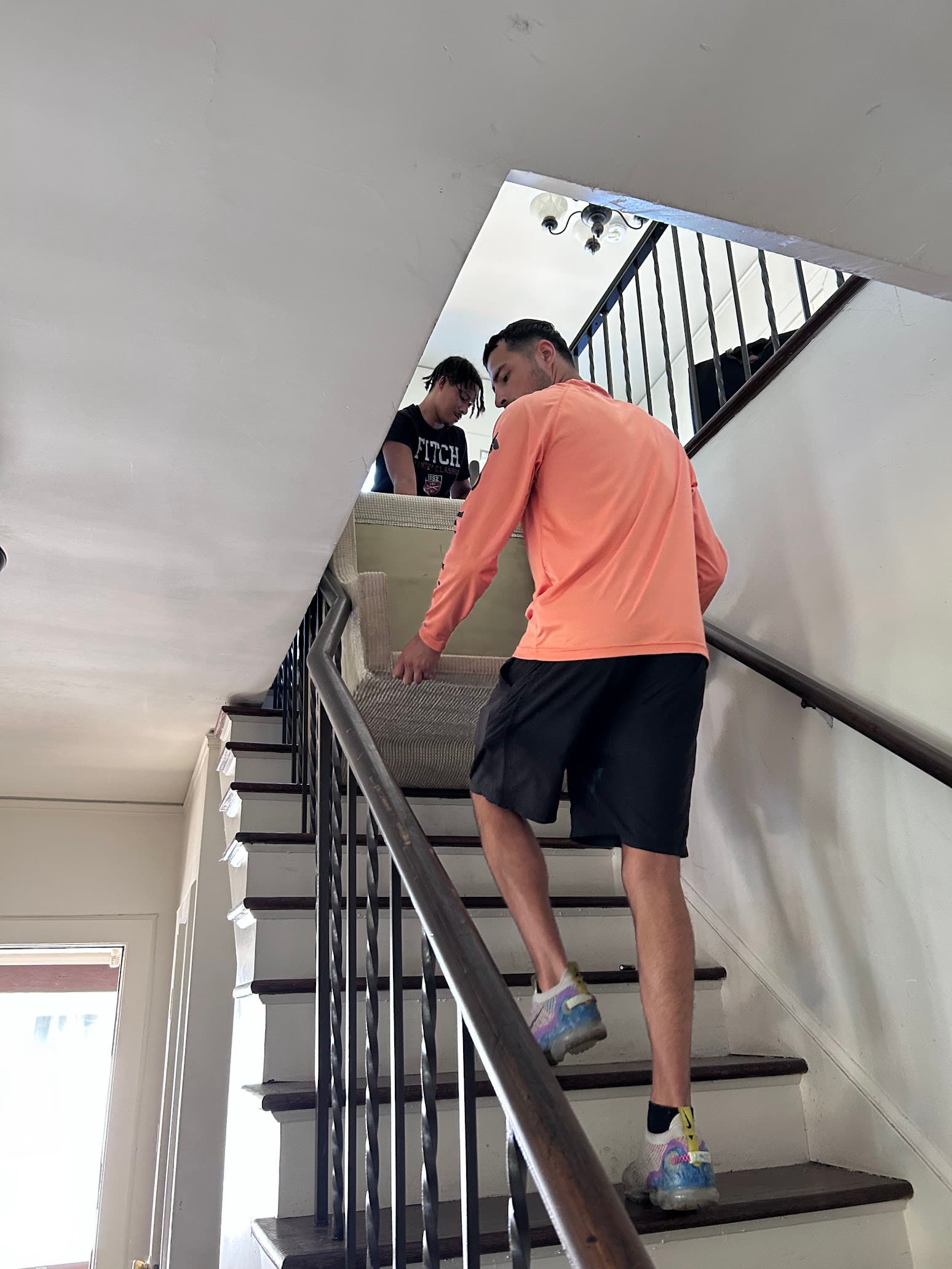Movers carrying furniture upstairs during a Tuscaloosa move