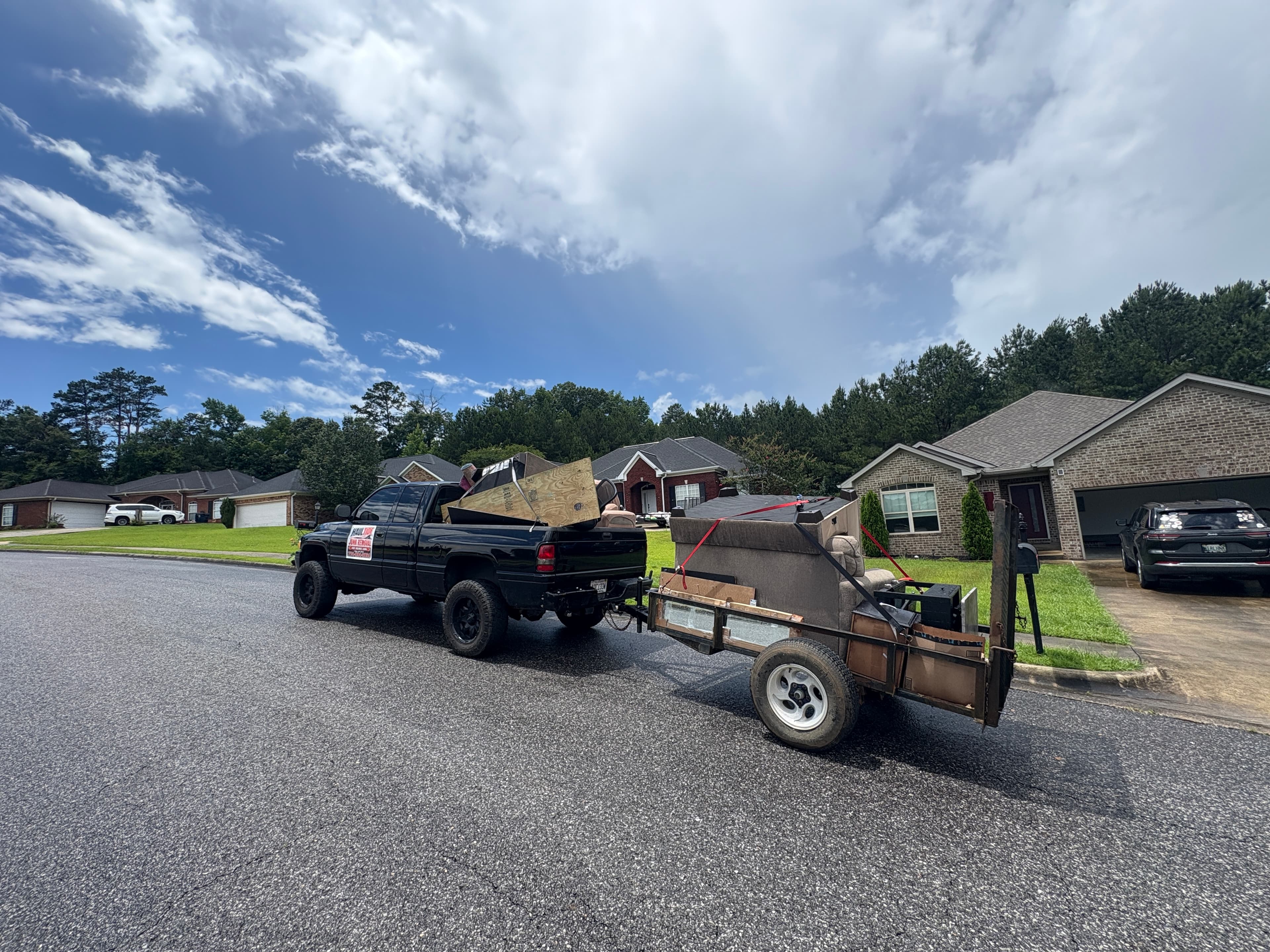 Haul Tide truck and moving trailer parked at a Tuscaloosa job site