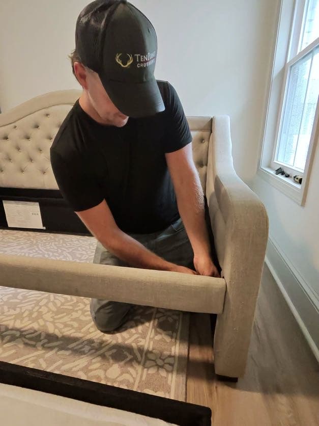 Haul Tide assembling furniture for a Tuscaloosa customer